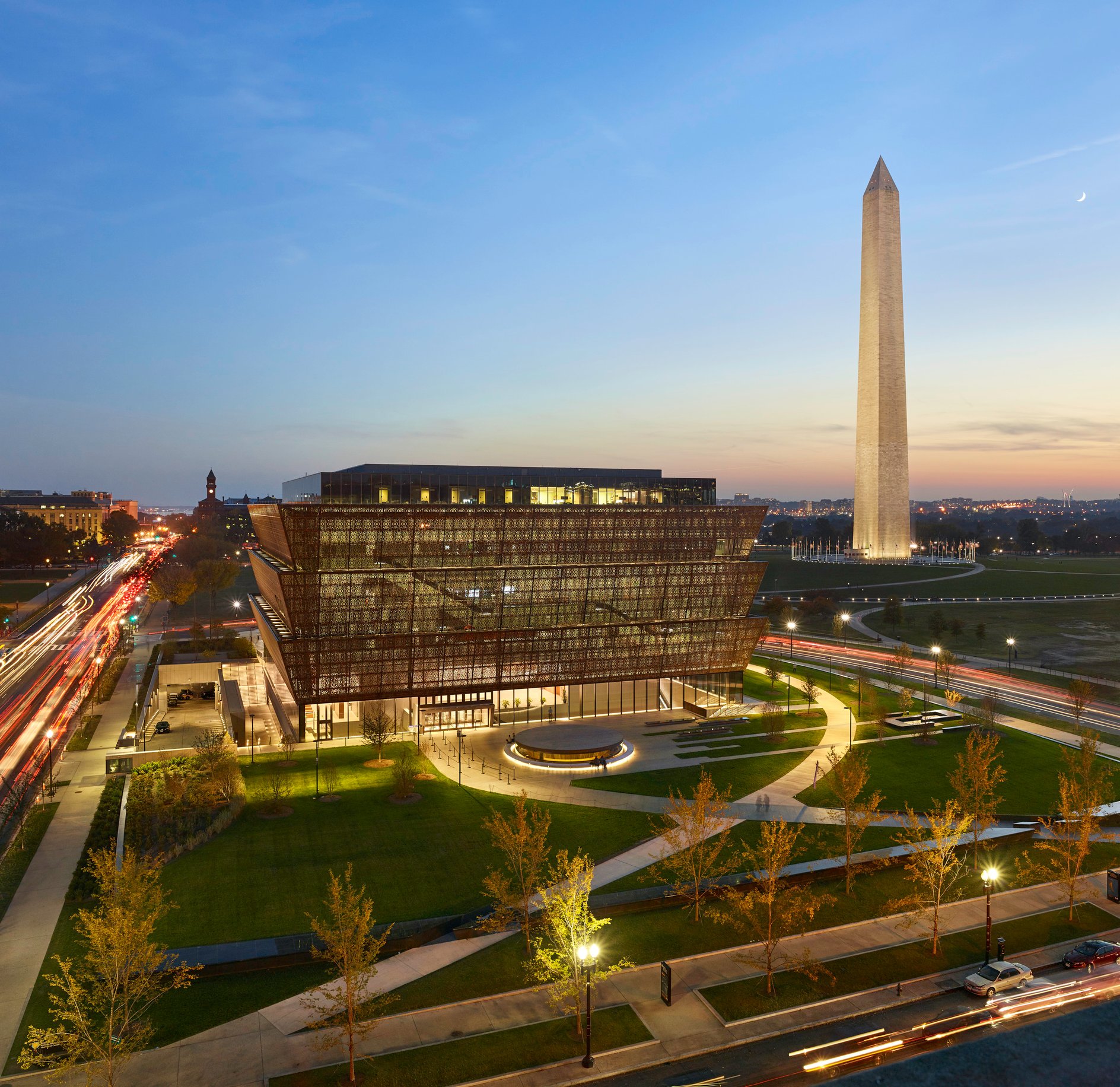 Aerial exterior of museum with Washington memorial in the background.