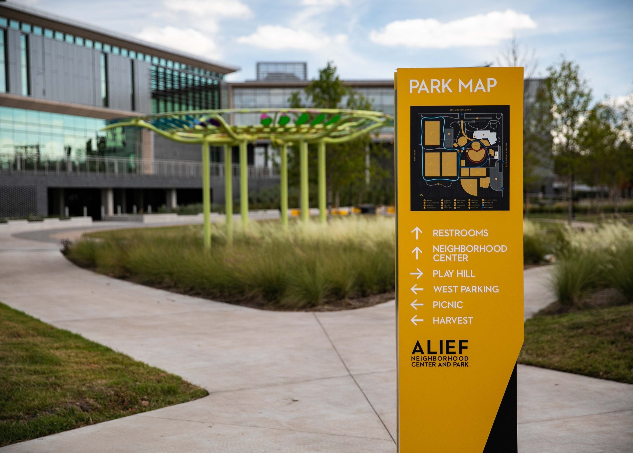To tie everything together, the center’s signature golden yellow branding is consistently applied to primary signs at key decision points, ensuring clarity and cohesion throughout the space.