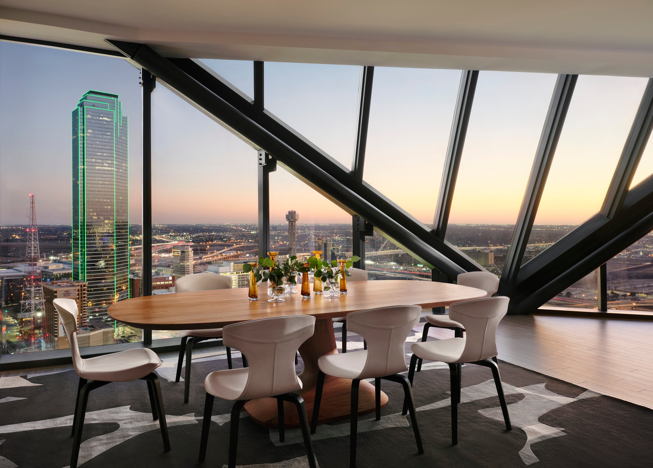 A large open-air dining space in a modern highrise apartment.