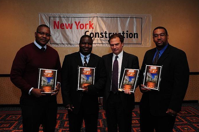 Nana left and Chris Grabé second from right receive an award for the John C Daniels School